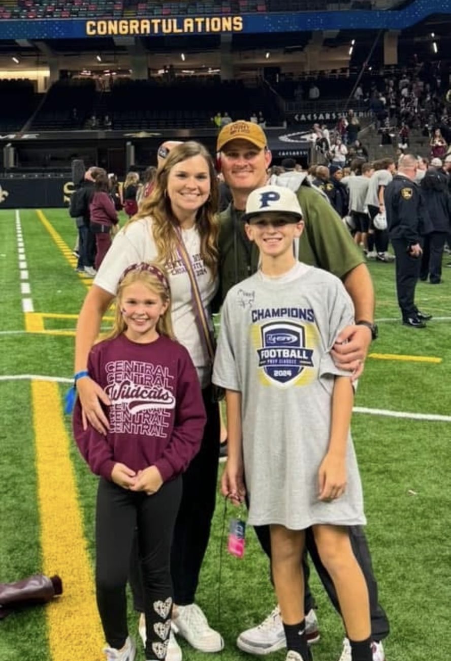 Coach Morris and family celebrating a championship at the Superdome
