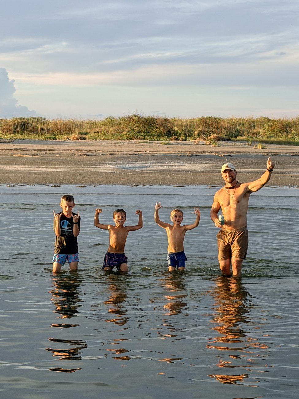 Coach Simoneaux and his boys outdoors in the water